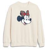 A cream-colored sweatshirt featuring a character with a plaid bow.
