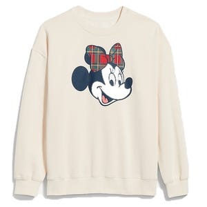A cream-colored sweatshirt featuring a character with a plaid bow.