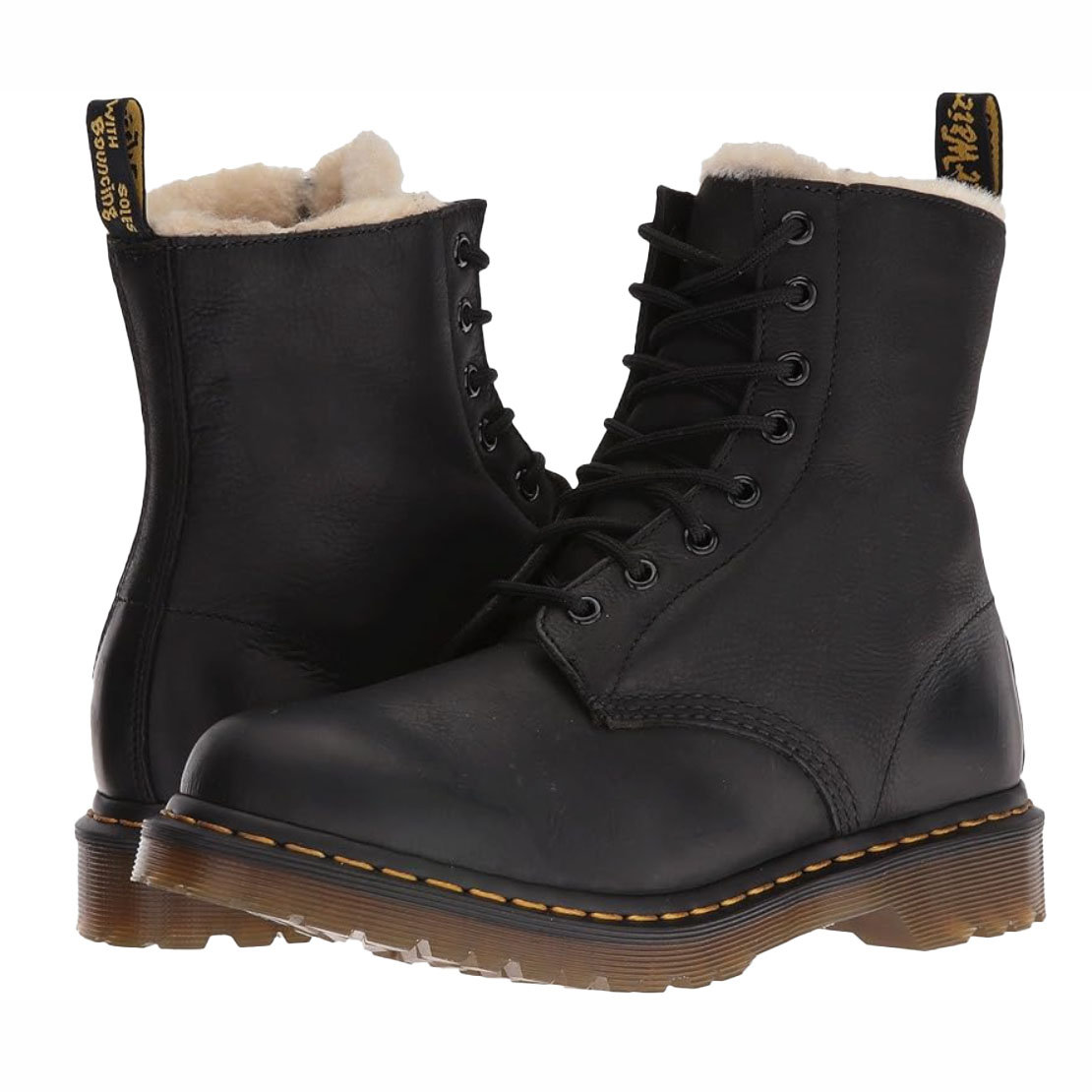 Black Dr. Martens Serena Boots with a lace-up design, featuring a soft, fur-lined interior and the classic yellow stitching on the sole.