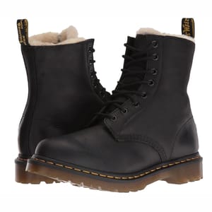 Black Dr. Martens Serena Boots with a lace-up design, featuring a soft, fur-lined interior and the classic yellow stitching on the sole.