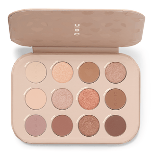 A makeup palette featuring 12 eyeshadow shades in a range of neutral and warm tones, including matte and shimmer finishes, each labeled with names.