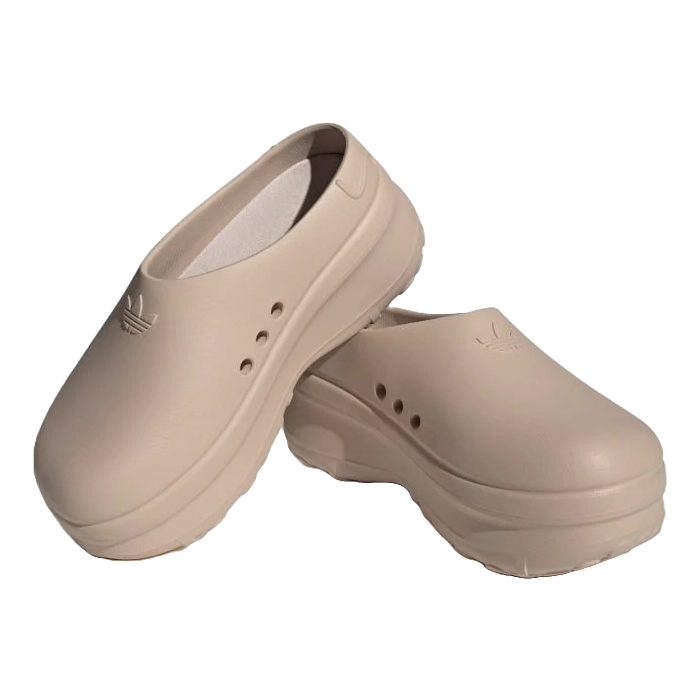 Beige slip-on clogs featuring the Adidas logo and ventilation holes on the sides, designed with a chunky sole.