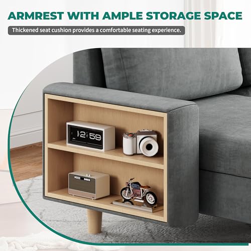 A gray sofa armrest includes built-in shelving for storage, featuring items like a clock, camera, and toy motorcycle for display.