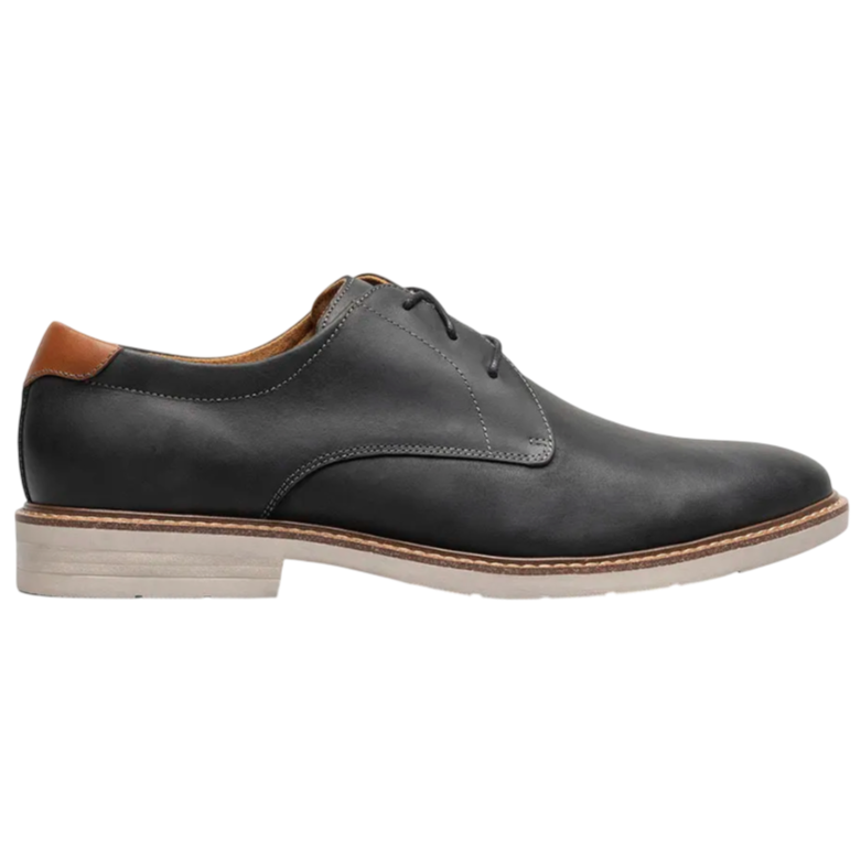A black leather oxford shoe with a brown accent on the heel and a light-colored sole, featuring minimal stitching and a sleek, modern design.