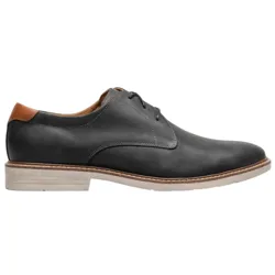 A black leather oxford shoe with a brown accent on the heel and a light-colored sole, featuring minimal stitching and a sleek, modern design.