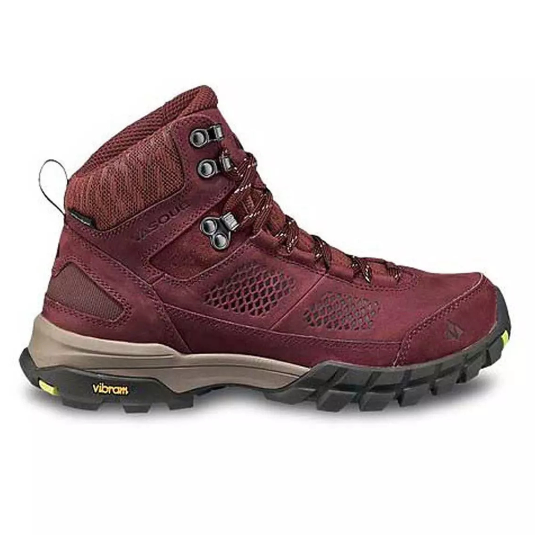 A maroon hiking boot with a high ankle design, featuring a Vibram sole for enhanced traction and metal eyelets for sturdy lacing.