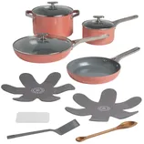 A cookware set featuring orange pots and pans with stainless steel handles, glass lids, and additional accessories like heat protectors, a spatula, and a wooden spoon.