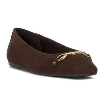 A brown suede flat shoe with a gold decorative buckle on the front, featuring a slight heel and a rounded toe.