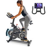 A person rides a stationary exercise bike equipped with a digital screen. Additionally, a close-up of the bike's handlebar and tablet holder setup is shown.