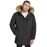 A man wearing a black parka with a faux fur-lined hood stands with his hands in the pockets. The jacket features a button-up front and drawstring adjusters.