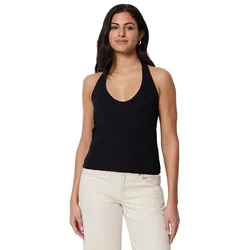 A woman wearing a black halter top paired with beige pants.