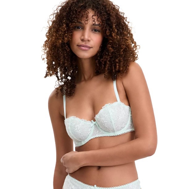 A woman is wearing a light blue lace bra with underwire support and matching lace panties. The design features delicate lace patterns and adjustable straps.