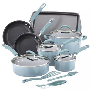 Cookware set including two frying pans, a saucepan, two pots with lids, a sauté pan with lid, a baking sheet, and utensils (spatula, brush, and scrubber). The handles and accessories are in a light blue color.