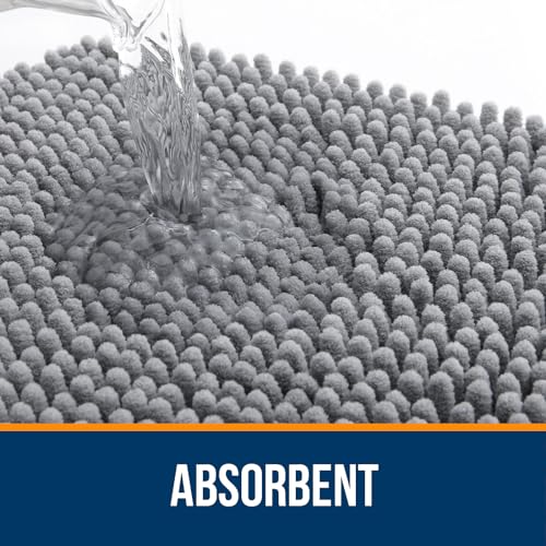 A thick, plush chenille bath rug with a highly absorbent texture is depicted with water being poured onto it, demonstrating its absorbency.