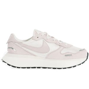 Nike Phoenix Waffle Sneakers feature a soft pink and white color scheme with a classic Swoosh logo, cushioned midsole, and a textured outsole for traction. They have a sleek, retro-inspired design combining suede and textile materials.