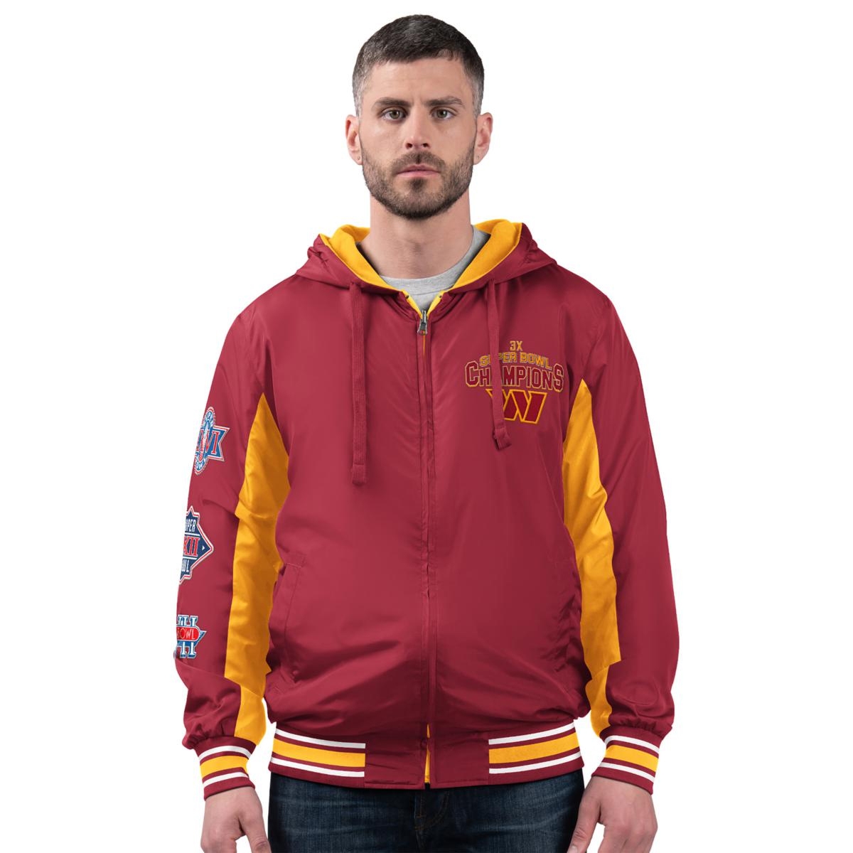 A man wears a maroon and yellow jacket with \“3X Super Bowl Champions\“ and a \“W\“ logo. The sleeves showcase multiple football championship patches.