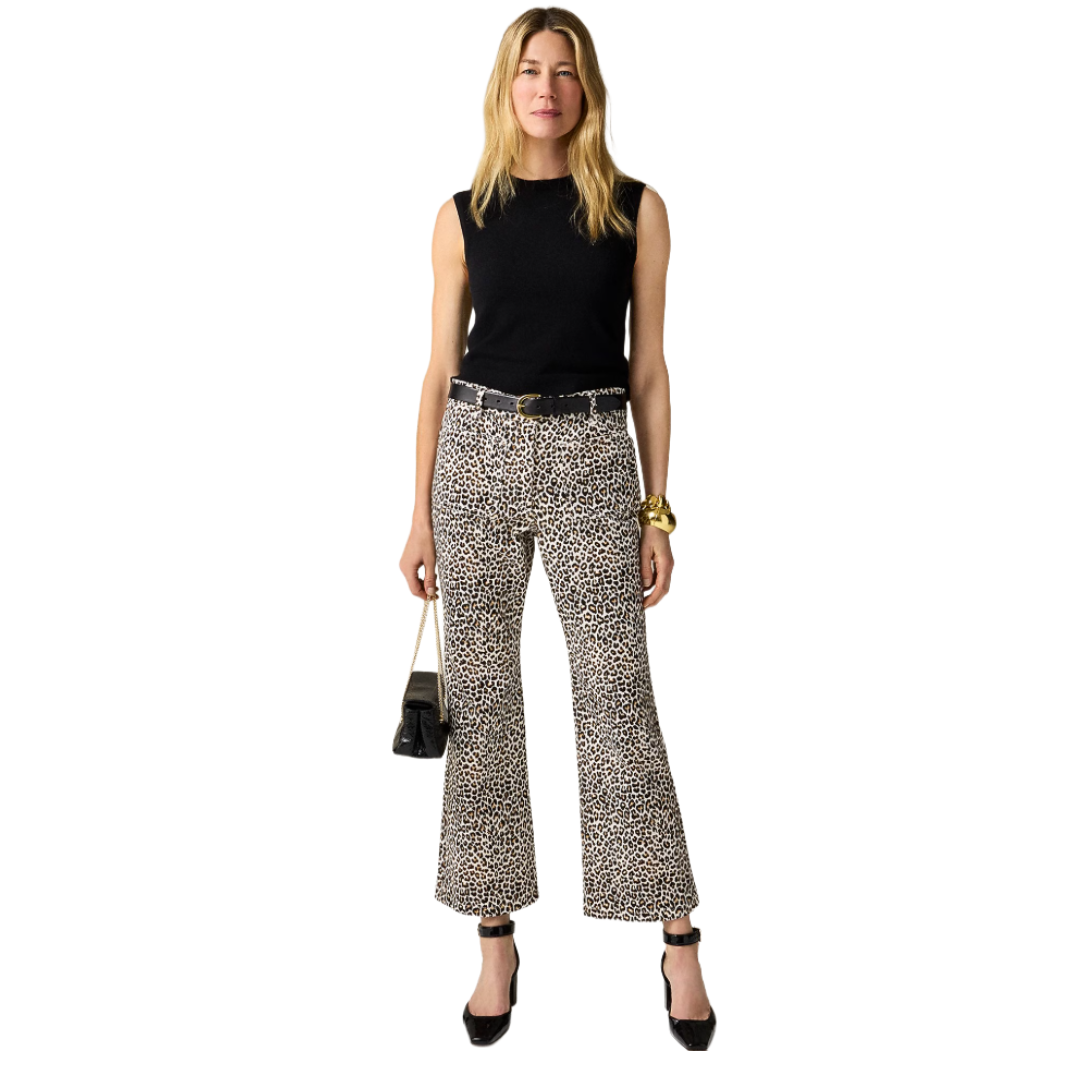 Sleeveless black top, leopard print bell-bottom pants, black belt with a gold buckle, black handbag, chunky gold bracelet, and black ankle-strap heels.