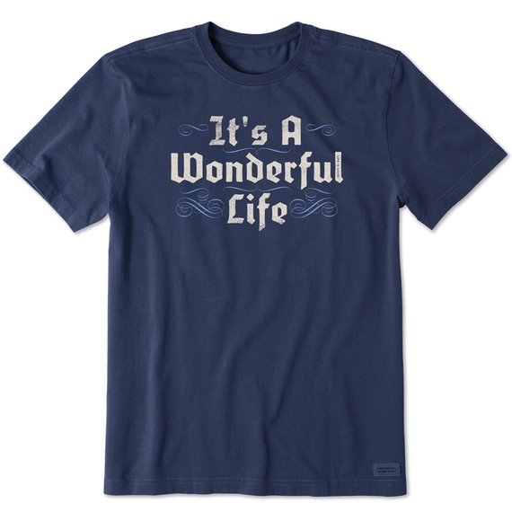A dark blue T-shirt with the phrase \“It's A Wonderful Life\“ in large, decorative white lettering, featuring subtle decorative swirls above and below the text.
