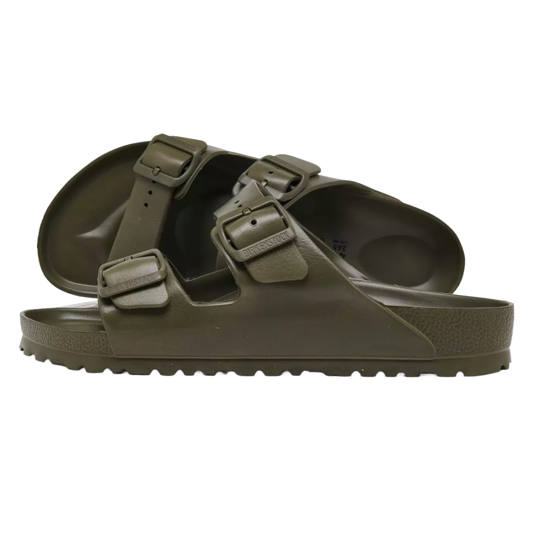 Pair of dark green slip-on sandals with two adjustable straps and textured soles.