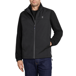 A man is wearing a black softshell jacket with a front zipper and a small logo on the chest, paired with dark jeans.