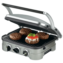 A countertop grill with adjustable settings is cooking four burger patties, one topped with cheese, tomato, and basil.