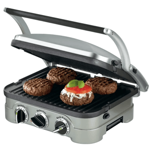 A countertop grill with adjustable settings is cooking four burger patties, one topped with cheese, tomato, and basil.