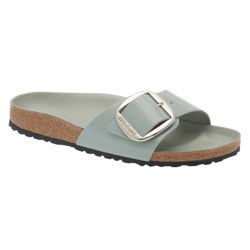 A single strap sandal with a cork footbed and a large buckle detail, featuring a light green color and black sole.