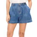 A person is wearing pleated denim shorts with a high waist, button closure, side pockets, and cuffed hems, paired with a white top.