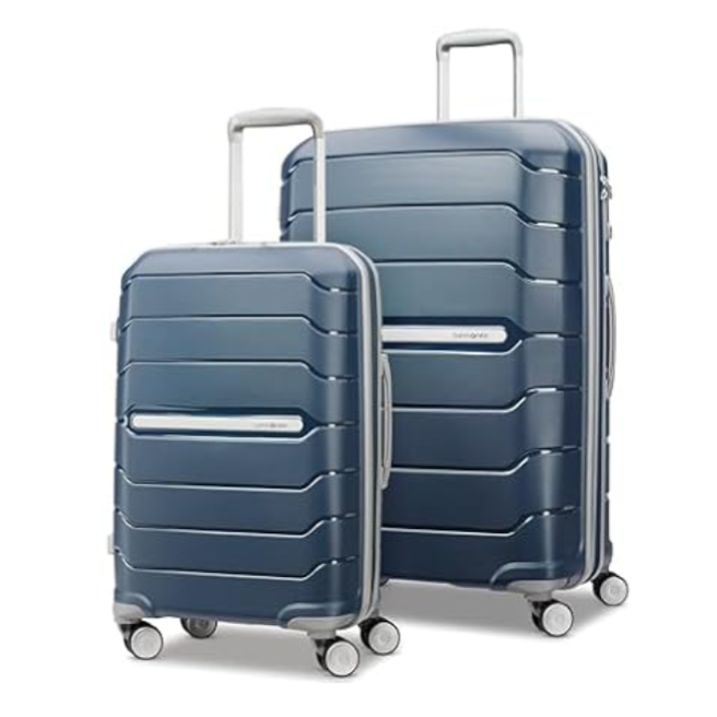 Two navy blue hard-shell spinner suitcases with silver handles and wheels, featuring a ribbed design for added durability.