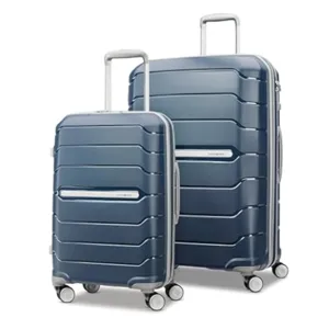Two navy blue hard-shell spinner suitcases with silver handles and wheels, featuring a ribbed design for added durability.