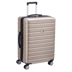 A gold-colored, hard-shell suitcase with a telescopic handle and four double-spinner wheels for easy mobility.
