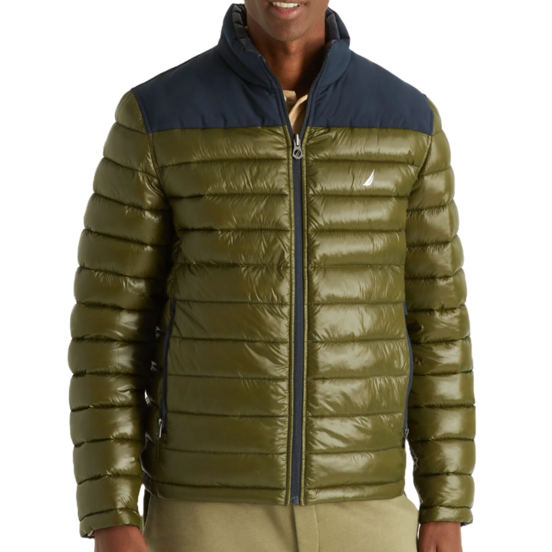 Nautica Reversible Jacket features an olive green, shiny quilted design with a contrasting navy top. It includes a front zipper and two side pockets, offering a versatile and stylish outerwear option.