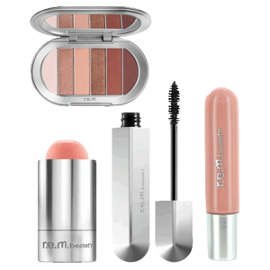 A collection of r.e.m. beauty products including an eyeshadow palette, blush stick, mascara, and lip gloss.