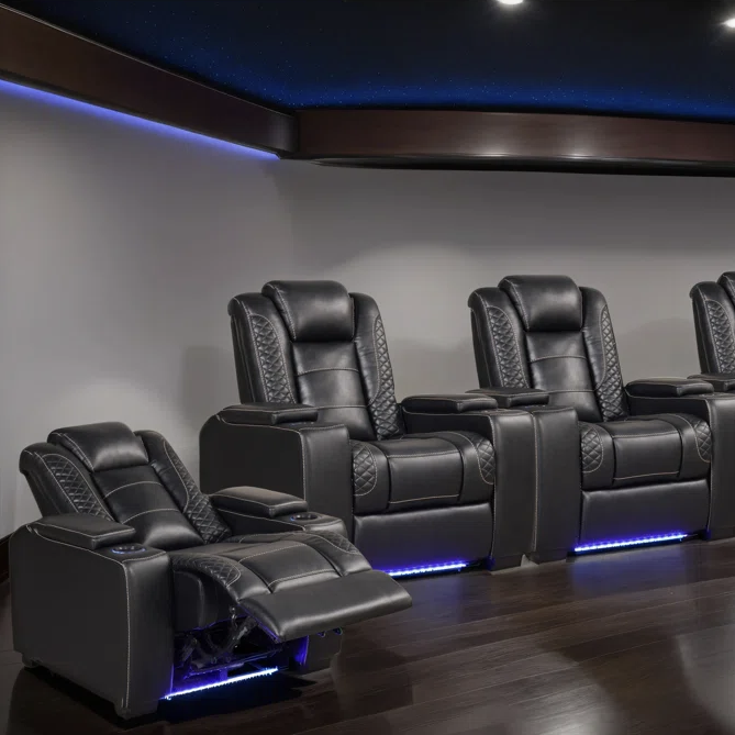 A row of black leather reclining theater chairs with quilted patterns, cup holders, and LED lighting underneath, ideal for a home theater setup.
