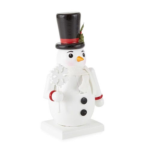 A decorative snowman nutcracker with a black top hat and holly accent, wearing a white suit with black buttons, a scarf, and holding a snowflake.