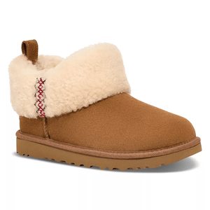 Tan suede boots with a fold-over shearling cuff, featuring red braided detailing on the side, a pull tab on the back, and a rubber sole for traction.
