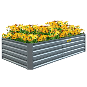 A rectangular metal raised garden bed filled with blooming yellow flowers.