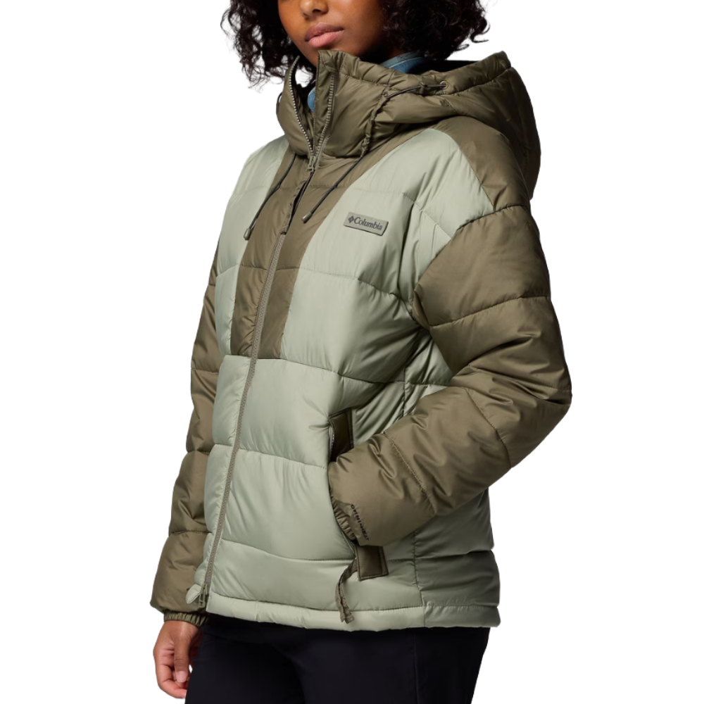 A person is wearing a Columbia puffer jacket in a two-tone color scheme with a hood and zipper closure.