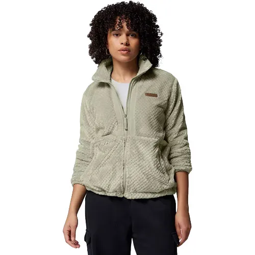 A woman wearing a light green fleece jacket with a zip-up front and two pockets, paired with dark pants.