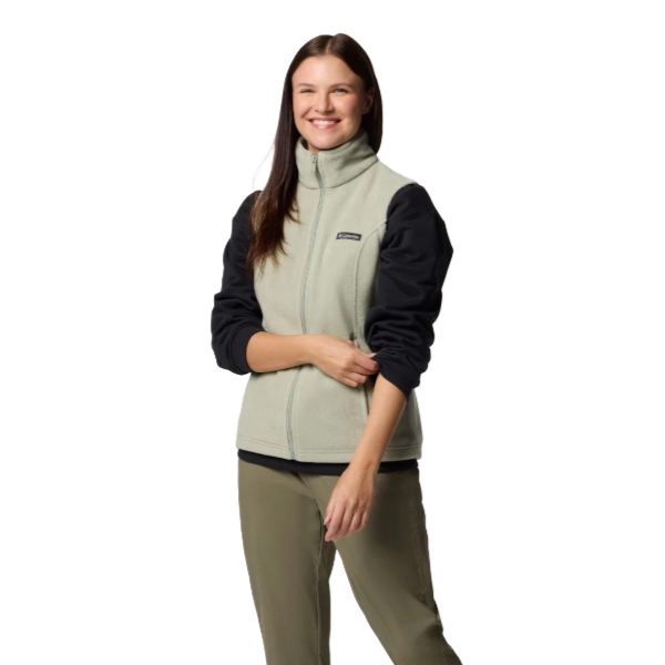 A woman is wearing a two-tone fleece jacket with a high collar and zip closure, paired with khaki pants.