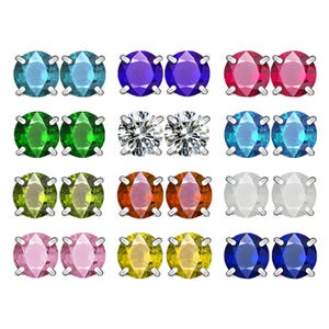 A set of stud earrings featuring various colored gemstones, including blue, purple, red, green, clear, orange, white, pink, yellow, and dark blue, all in silver prong settings.