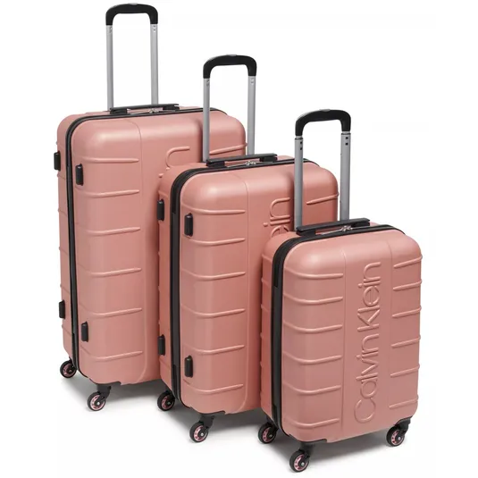 A set of three pink hard-shell suitcases with four-wheel spinners, telescopic handles, and the Calvin Klein logo embossed on the front.