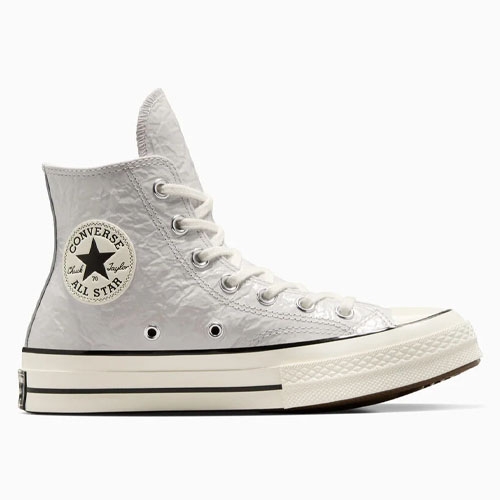 White high-top Converse Chuck Taylor All Star sneakers with a crinkled texture, featuring a classic design with a round rubber patch, black stripe accents, and metal eyelets.