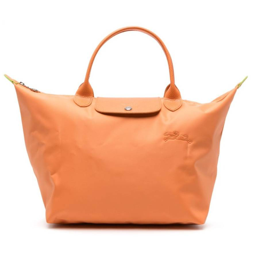 Orange Longchamp Le Pliage M Top Handle Bag with a minimalistic design, featuring a snap button closure, short handles, and a subtle embossed logo.