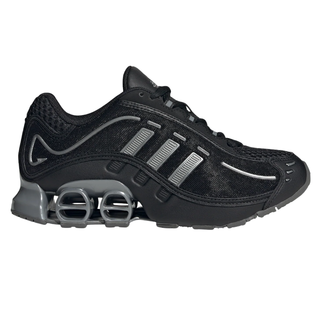 A black athletic shoe with grey accents, featuring a mesh upper and unique spring-like cushioning in the sole.