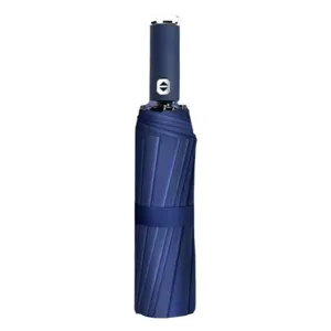 A compact blue umbrella with a sleek design and a button on the handle for automatic opening and closing.