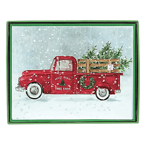 A holiday-themed card depicting a vintage red truck carrying Christmas trees in a snowy setting, with \“Holly Berry Tree Farm\“ written on the side.