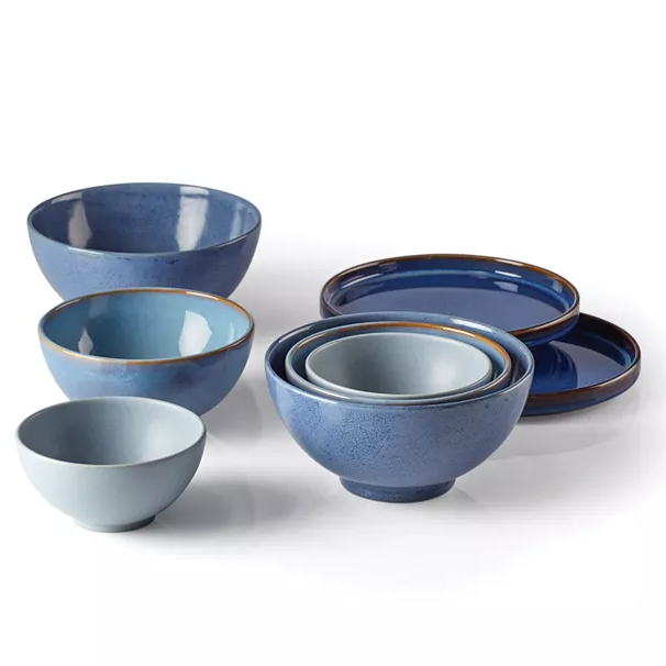 The Lenox 8pc Blue Nesting Dinnerware Set features a series of blue bowls and plates in various sizes, with a gradient finish and a simple, elegant design, ideal for modern table settings.