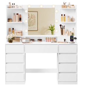 A white vanity desk with a large mirror surrounded by lights, equipped with shelves holding various cosmetic bottles, brushes, and accessories. It's accompanied by a power outlet featuring USB ports and a cable extending from the desk.