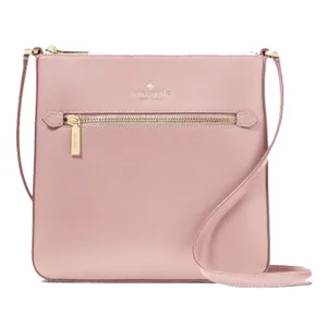 A blush pink crossbody bag with a slim design, featuring a front zipper pocket and an adjustable shoulder strap, branded with a logo at the top center.